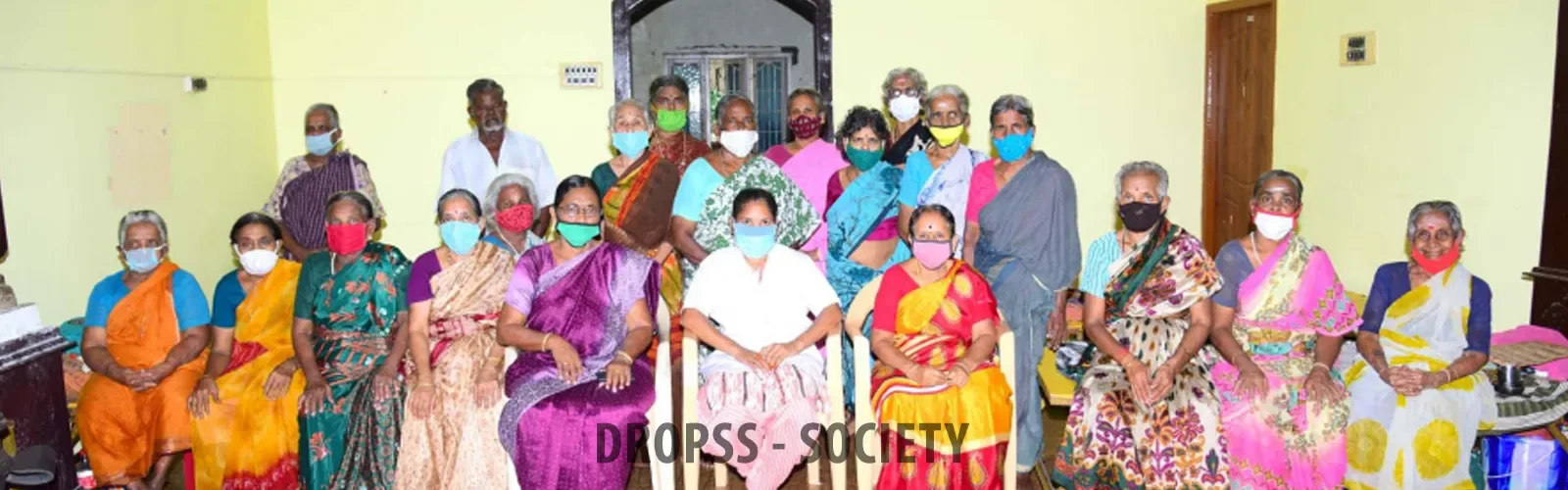 DROPSS residents and staff beneath the organisation's banner